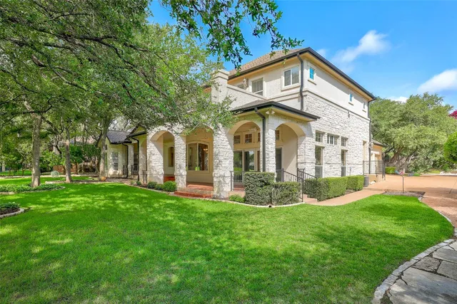 a living room with furniture a window and a chandelier