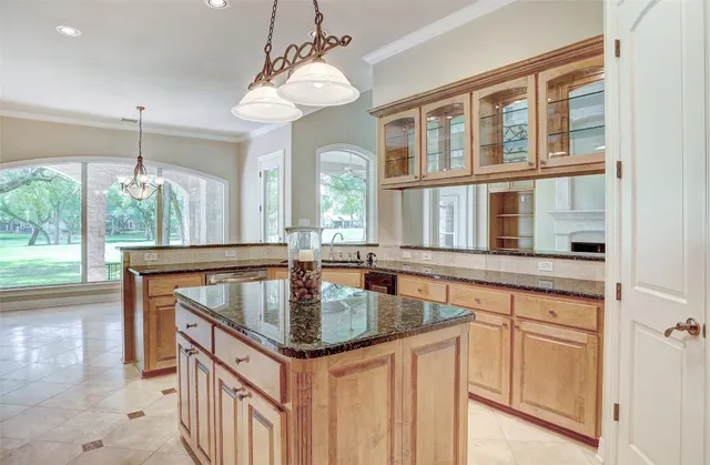 a kitchen with stainless steel appliances granite countertop a stove and more cabinets
