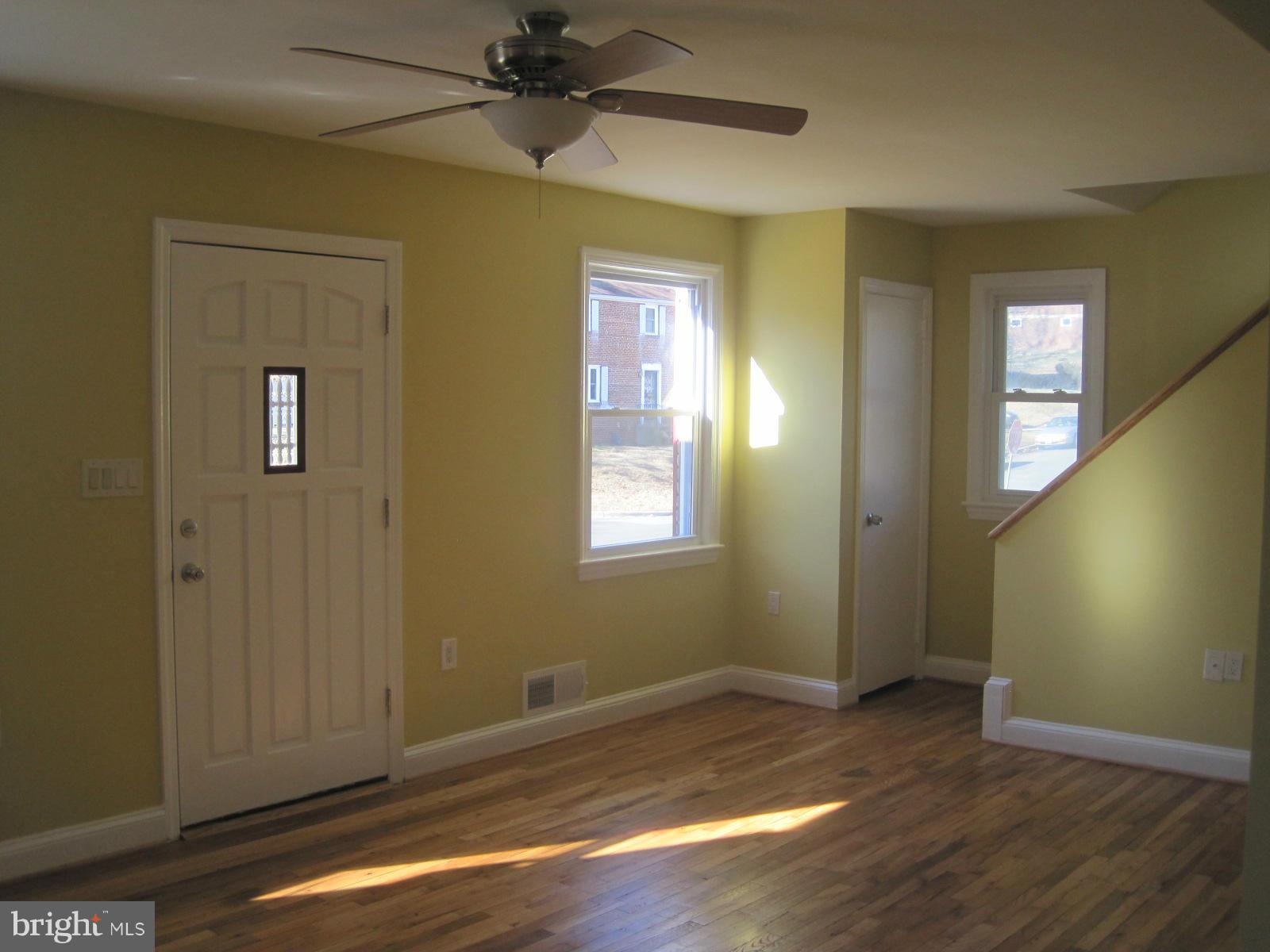 6517 Red Top Road Hyattsville, MD 20783 - Photo 6 of 23 a view of an empty room with wooden floor and a window