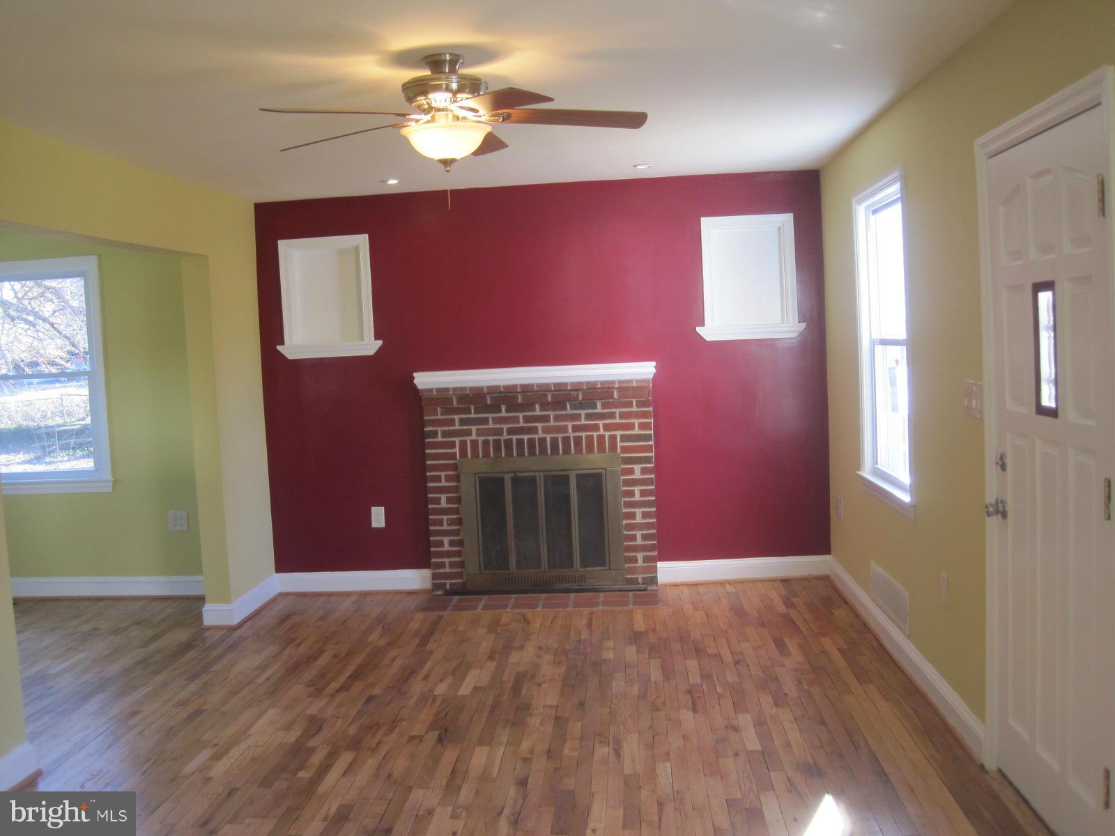 6517 Red Top Road Hyattsville, MD 20783 - Photo 7 of 23 a view of an empty room with window and wooden floor