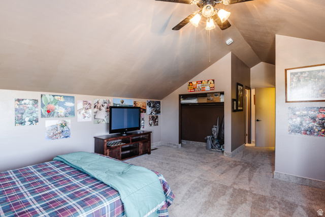 1470 Redwood Tree Street St. George, UT 84790 - Photo 31 of 53 Carpeted room with sloped ceilings, ceiling fan with light fixture, built-in shelving, and a dark brown media console