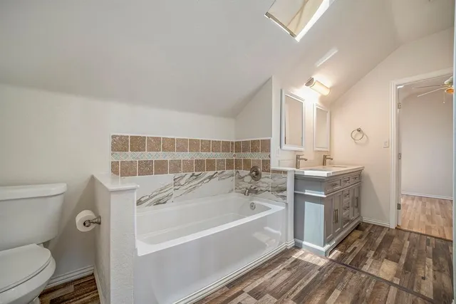 a bathroom with a bathtub sink and toilet