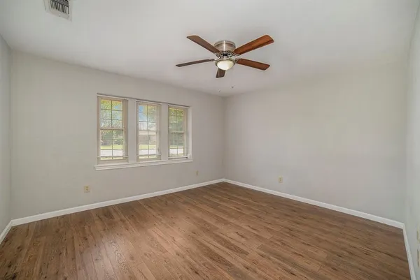 a view of a room with wooden floor and windows