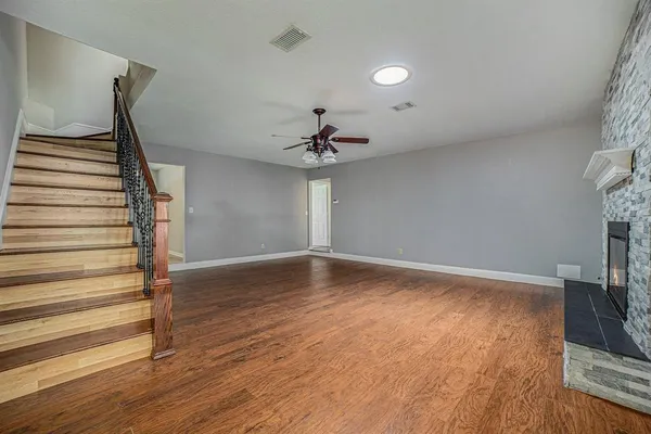 wooden floor in an empty room with a window