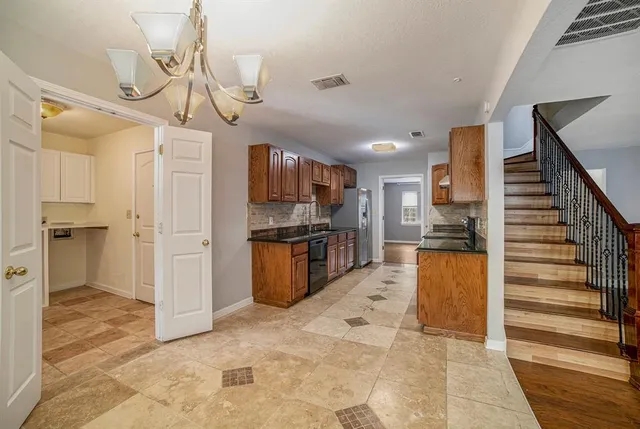 a view of kitchen with sink and refrigerator