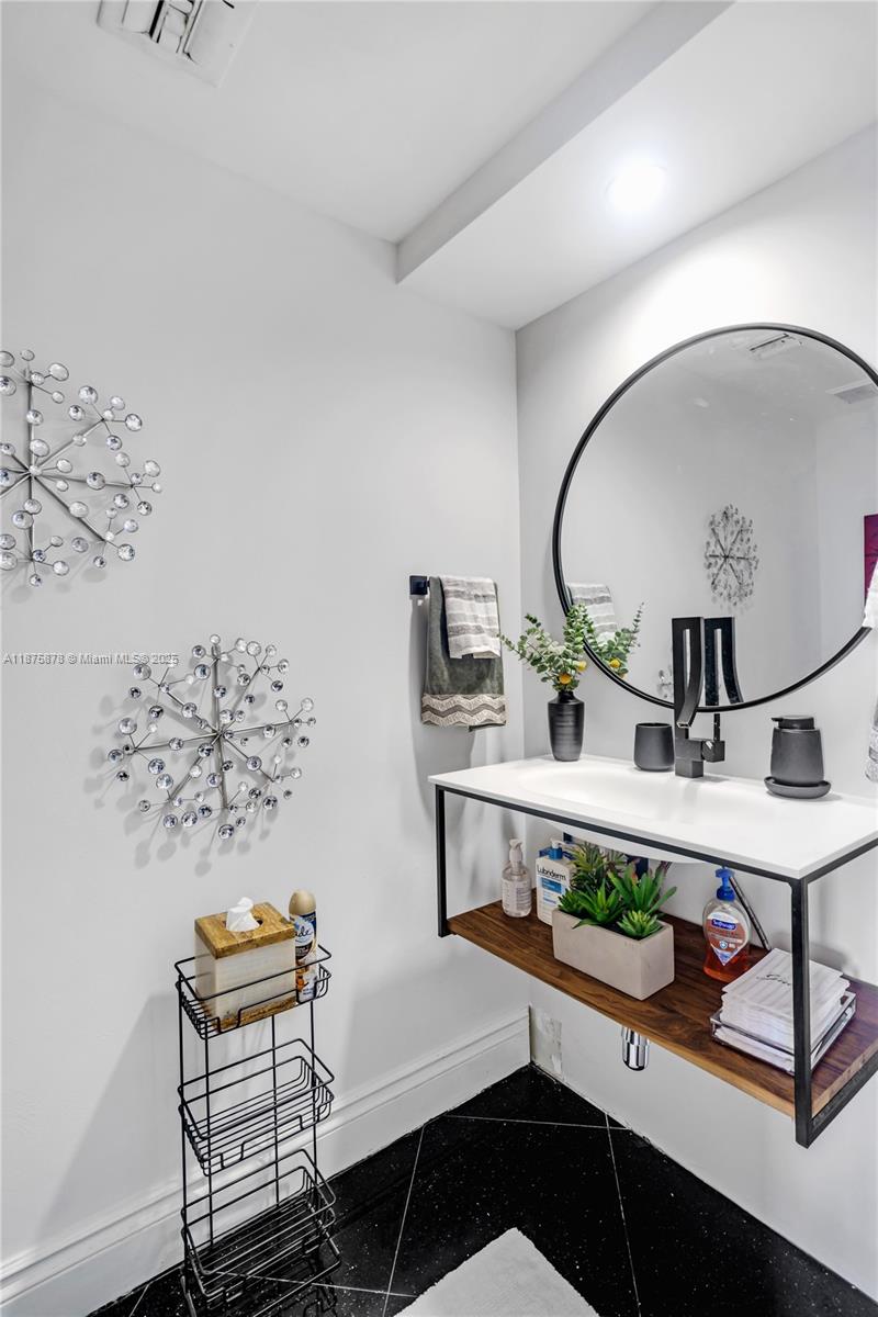 848 Brickell Key Drive, Unit 3803 Miami, FL 33131 - Photo 30 of 42 a view of a workspace room with wooden floor table and chairs