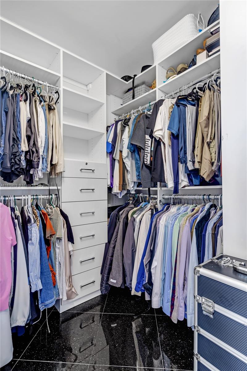 848 Brickell Key Drive, Unit 3803 Miami, FL 33131 - Photo 40 of 42 a view of walk in closet with clothes