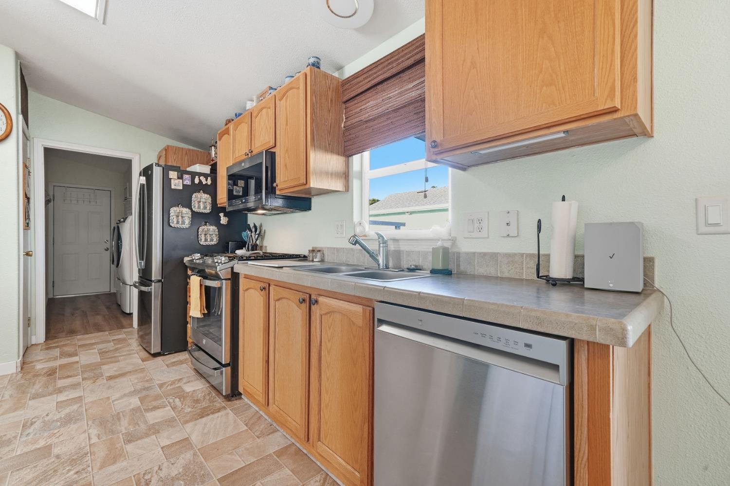 1400 West Marlette Street, Unit 33 Ione, CA 95640 - Photo 13 of 33 a kitchen with stainless steel appliances granite countertop a sink and a refrigerator