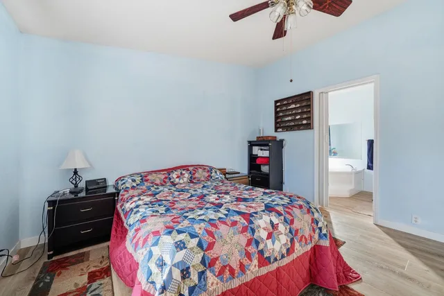 a bedroom with a bed and a book shelf