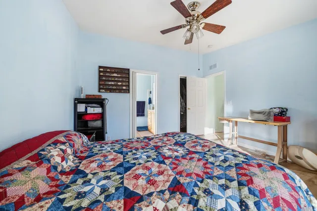 a bedroom with bed and a chandelier
