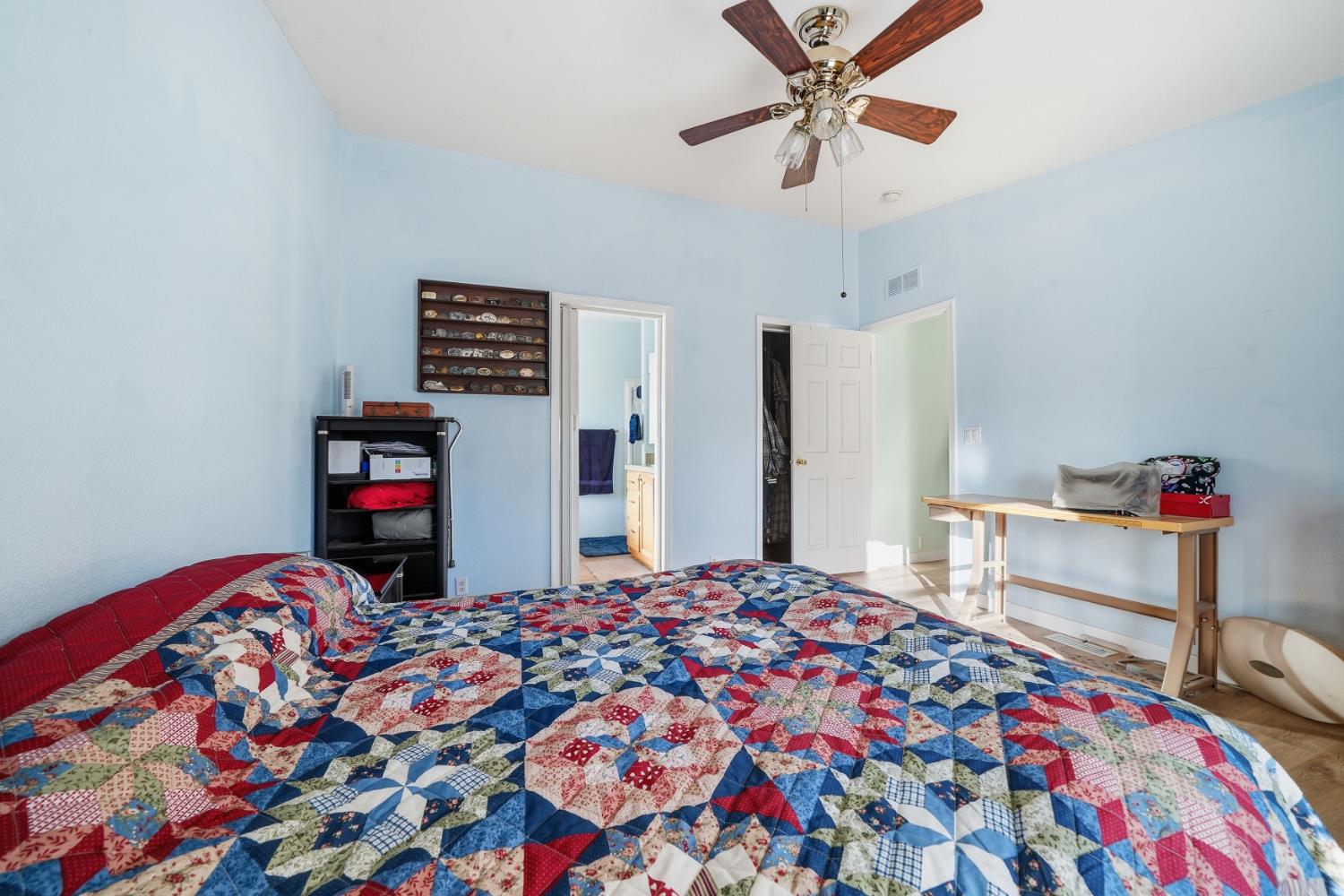 1400 West Marlette Street, Unit 33 Ione, CA 95640 - Photo 20 of 33 a bedroom with bed and a chandelier