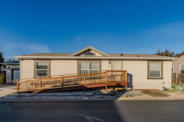 a view of a house with a wooden deck