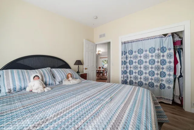 a bedroom with a bed and a chair