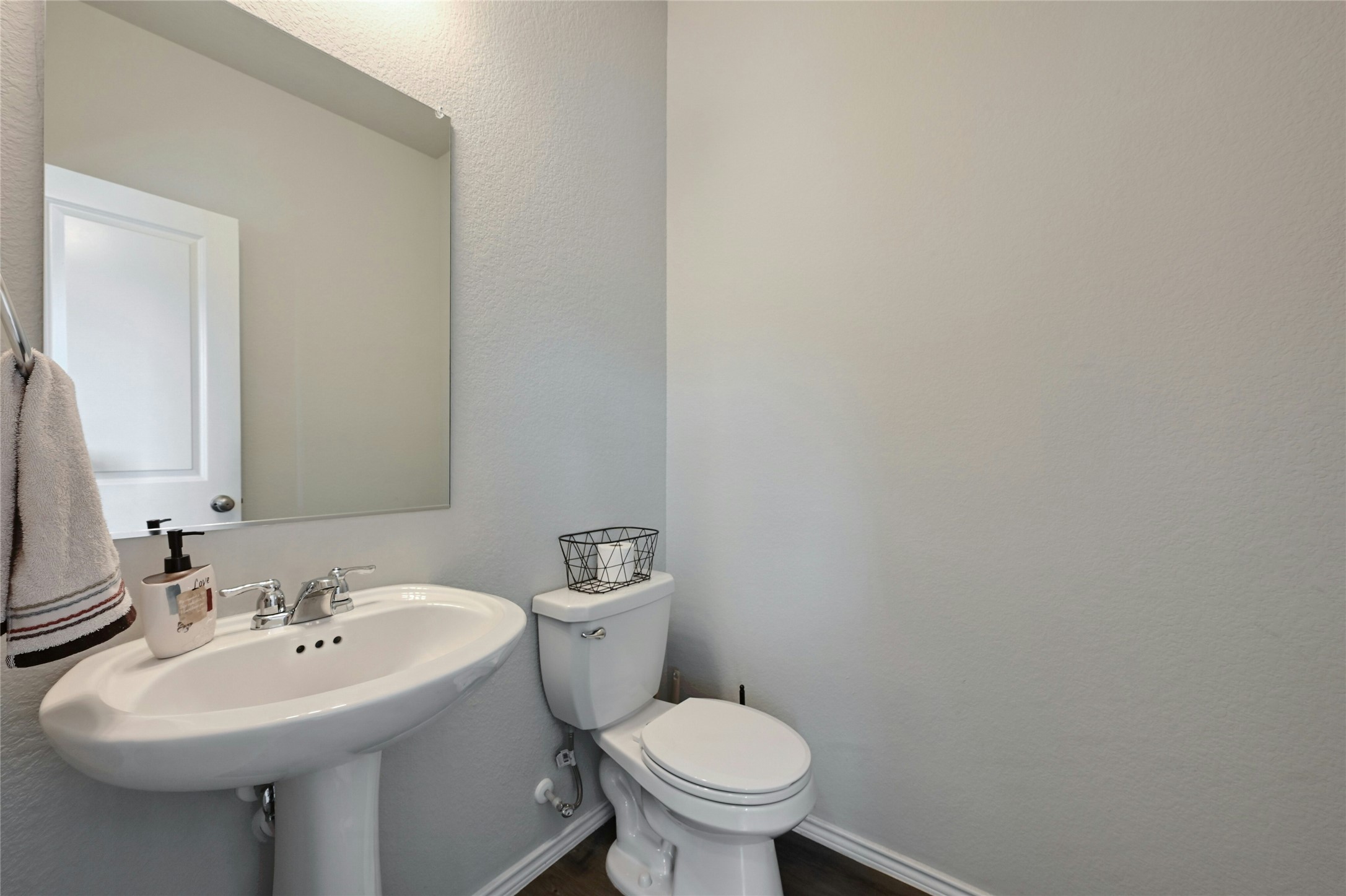 100 Comet Drive, Unit 1I Jarrell, TX 76537 - Photo 11 of 25 Bathroom featuring a textured wall and wood finished floors
