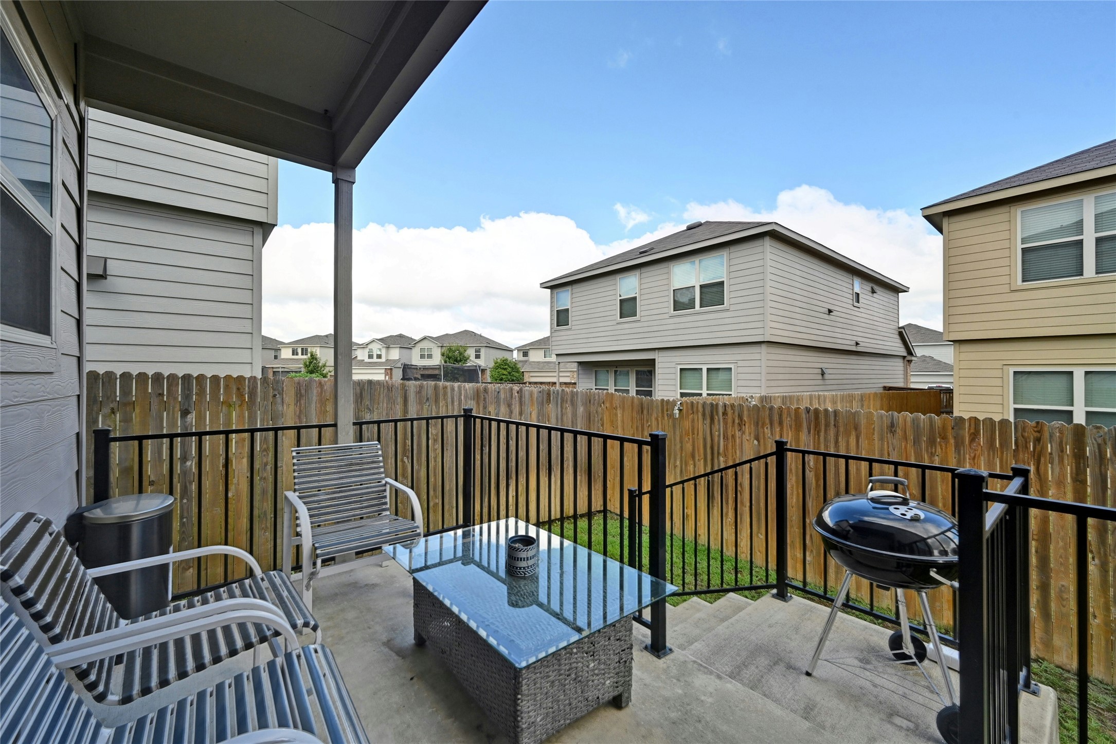 100 Comet Drive, Unit 1I Jarrell, TX 76537 - Photo 15 of 25 Fenced backyard with a residential view and a grill