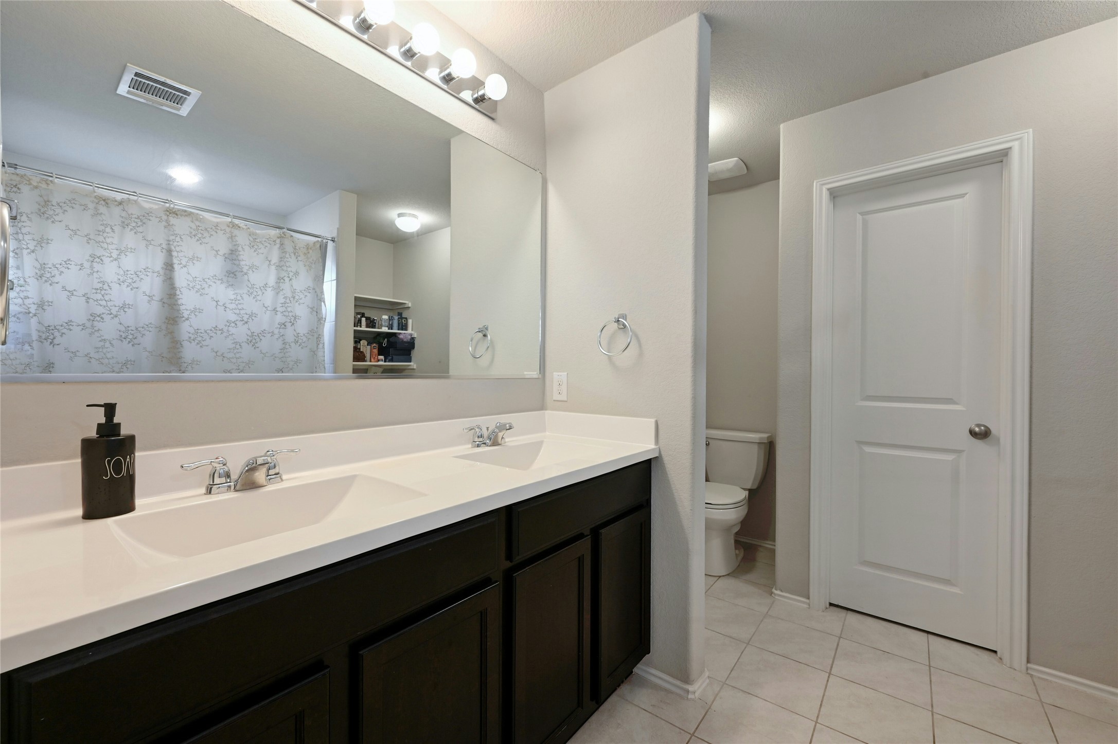 100 Comet Drive, Unit 1I Jarrell, TX 76537 - Photo 5 of 25 Full bathroom with tile patterned flooring and double vanity