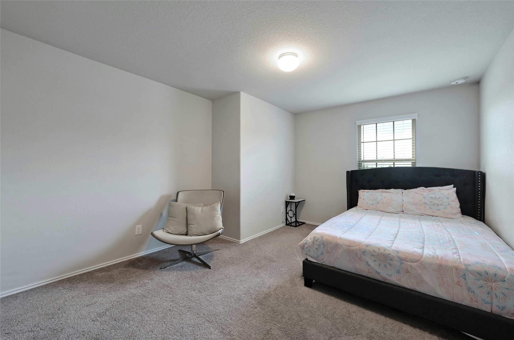100 Comet Drive, Unit 1I Jarrell, TX 76537 - Photo 9 of 25 Bedroom featuring carpet floors and a textured ceiling
