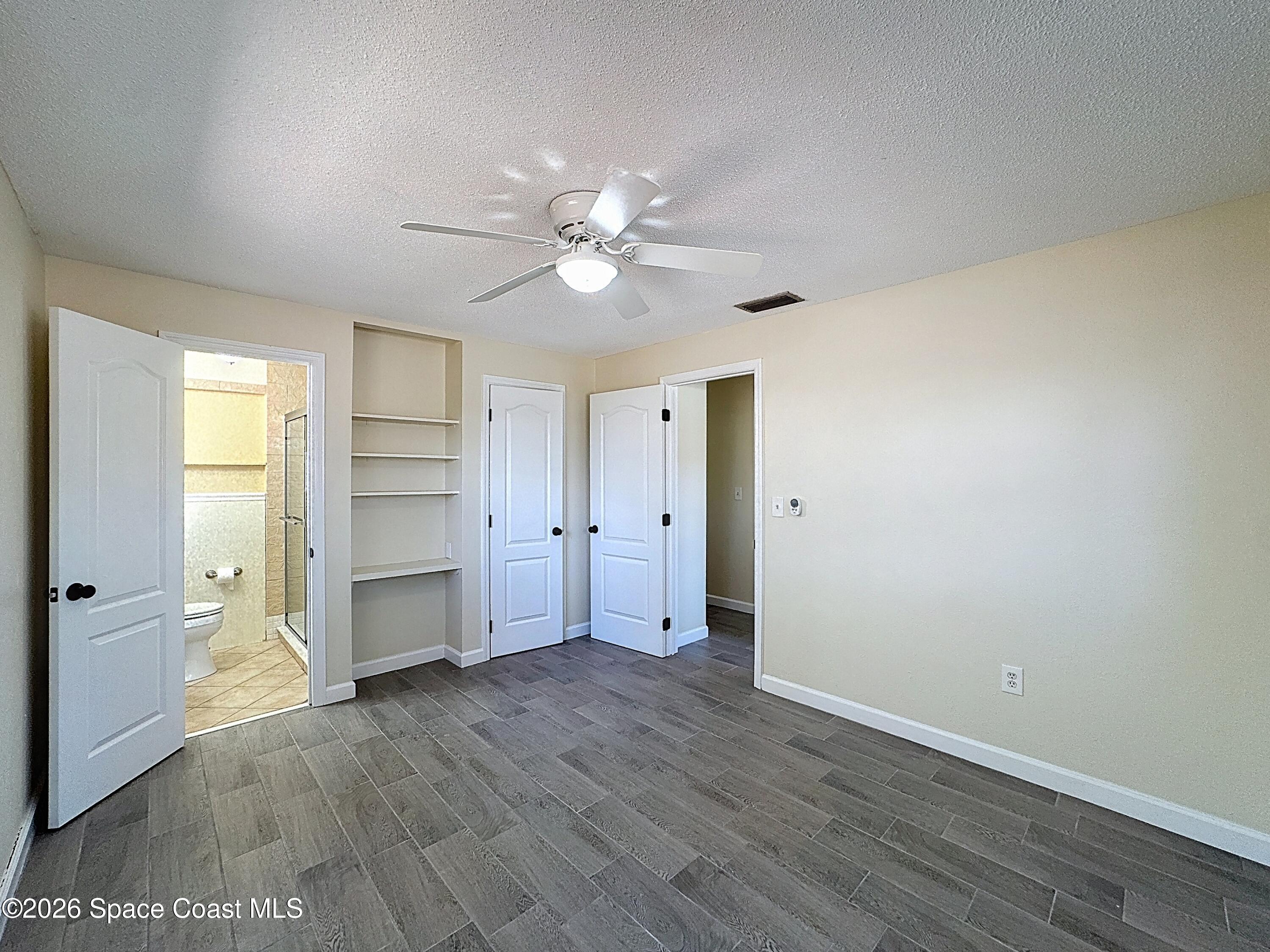 1315 Lester Court Merritt Island, FL 32952 - Photo 18 of 40 wooden floor in an empty room with a window