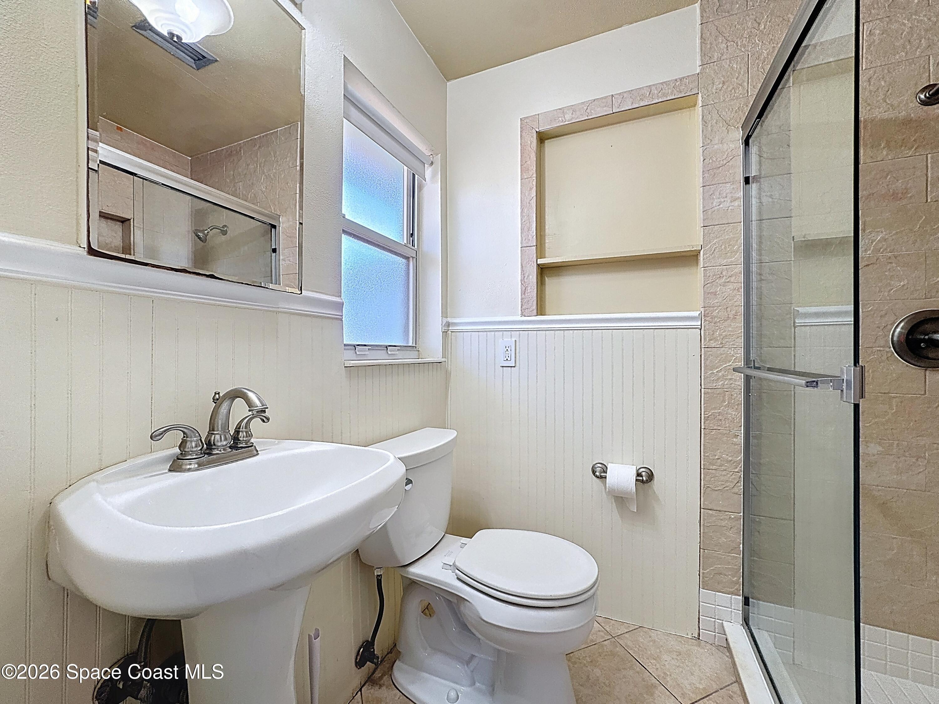 1315 Lester Court Merritt Island, FL 32952 - Photo 20 of 40 a bathroom with a sink toilet and a mirror