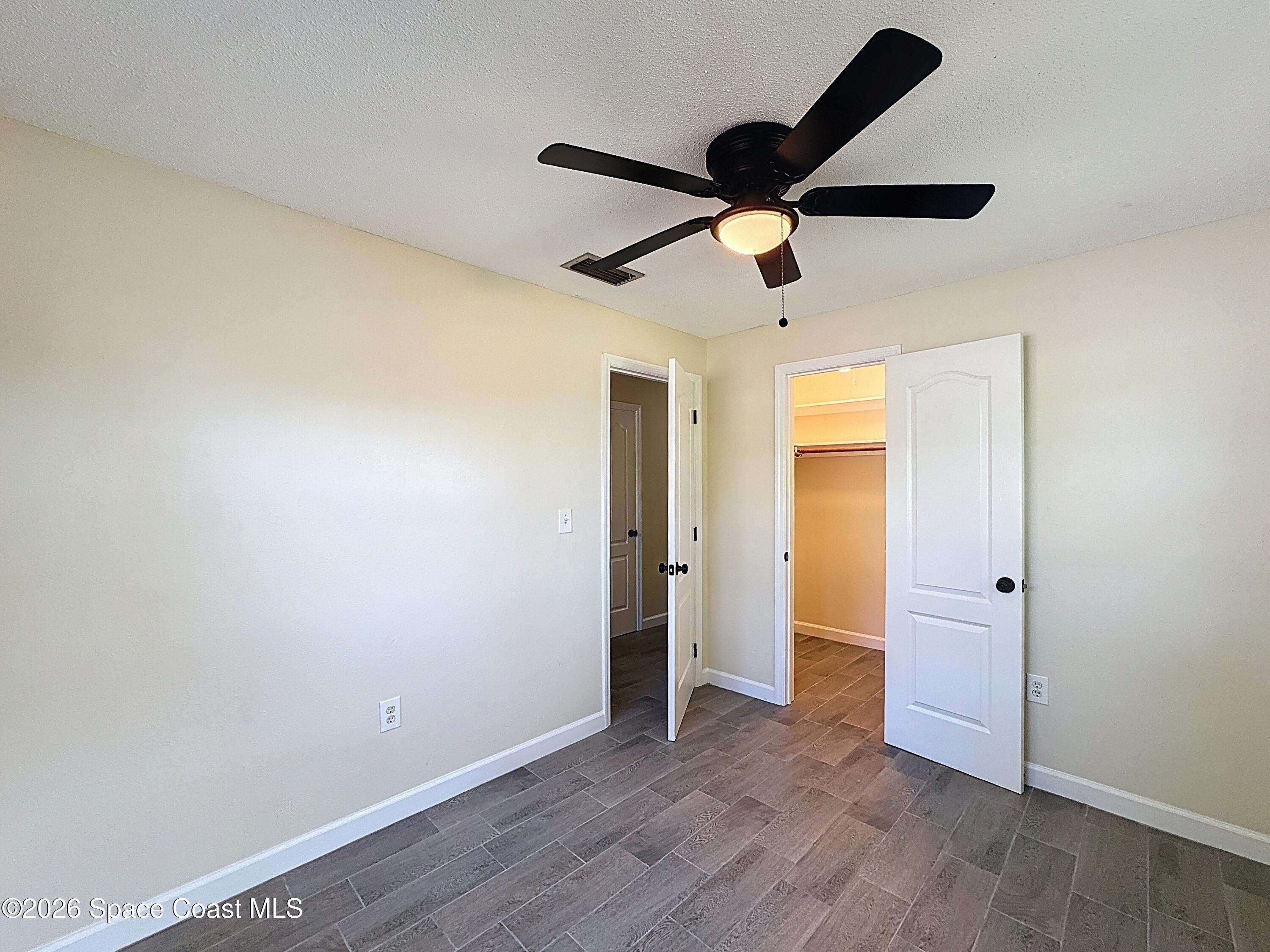 1315 Lester Court Merritt Island, FL 32952 - Photo 27 of 40 an empty room with wooden floor and windows