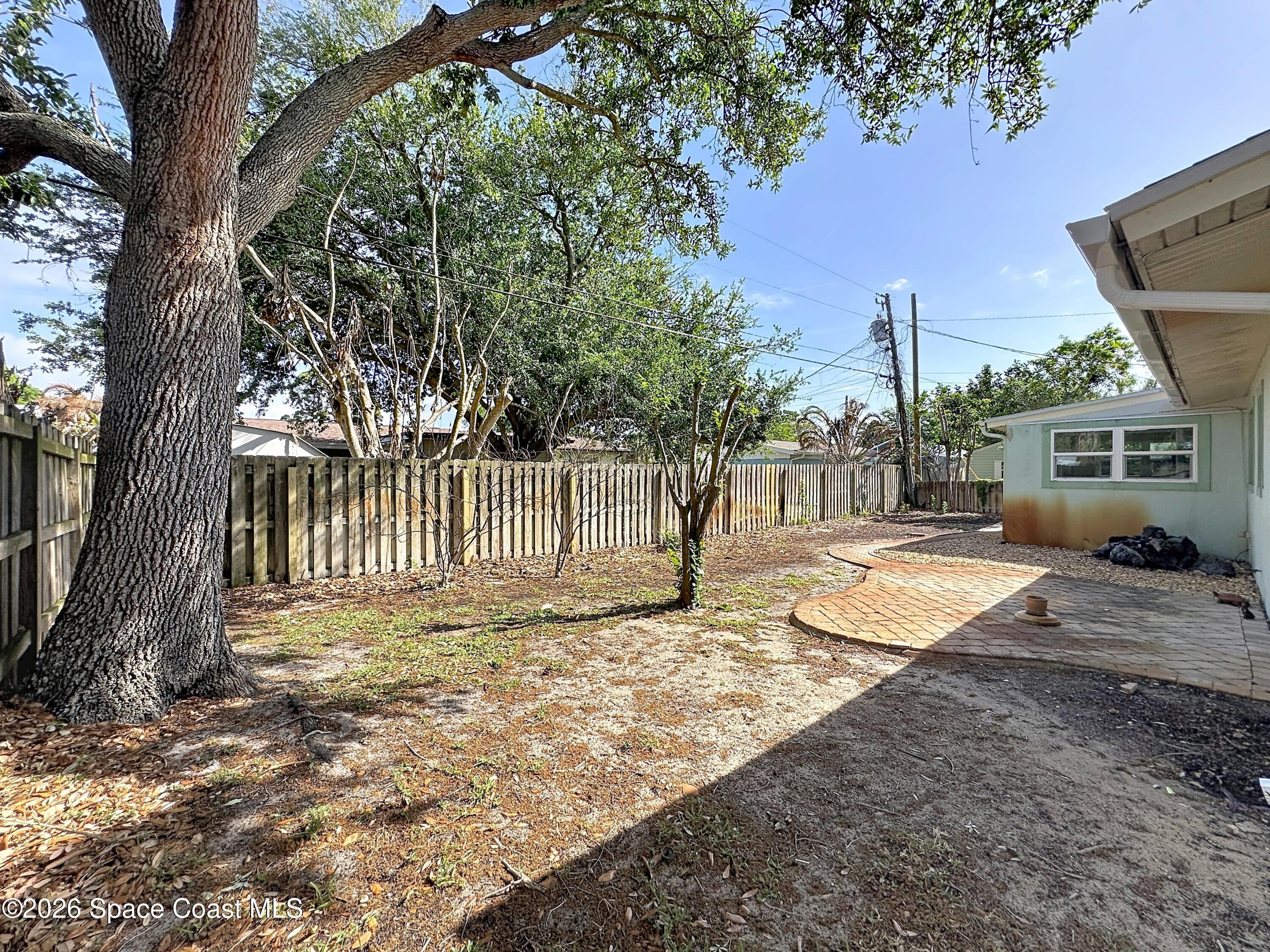 1315 Lester Court Merritt Island, FL 32952 - Photo 36 of 40 a view of a yard with a house in the background