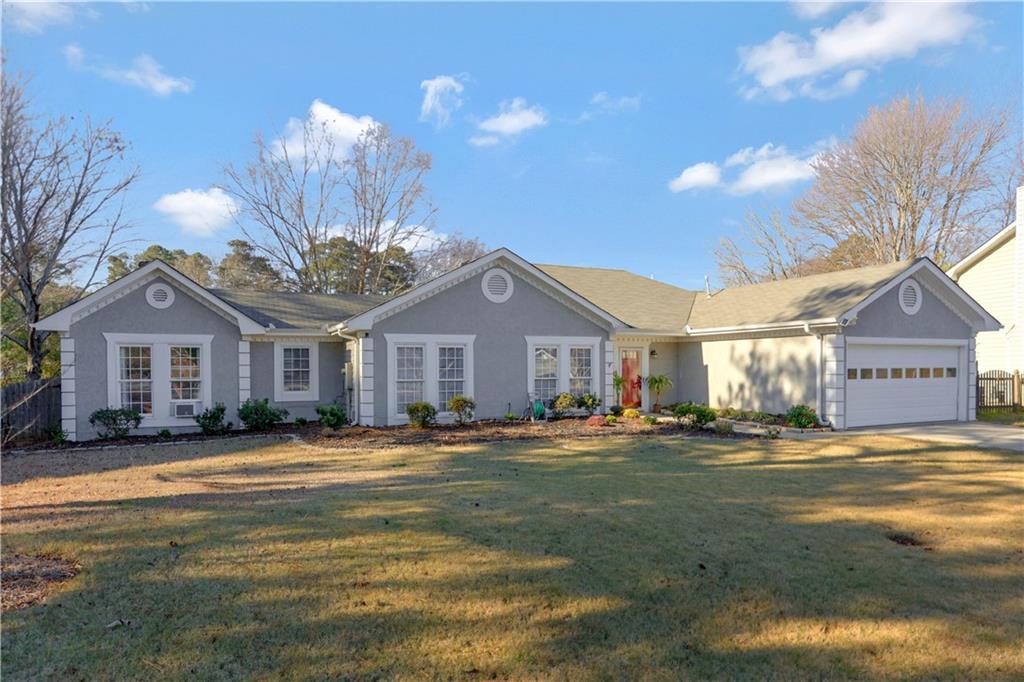 a view of a big house with a big yard and large trees