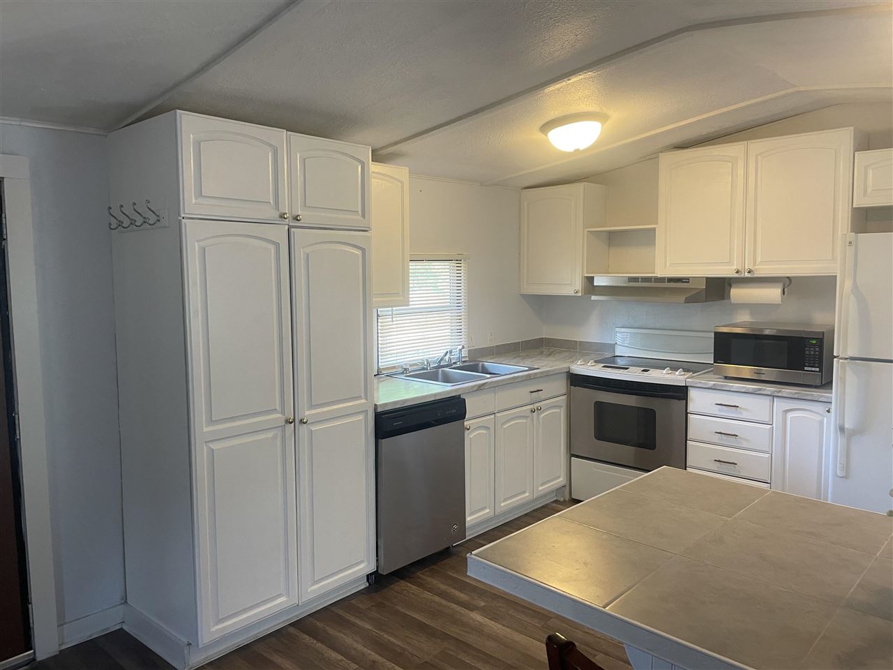 3268 E Road, Unit 43 Clifton, CO 81520 - Photo 5 of 15 a kitchen with a refrigerator stove and sink