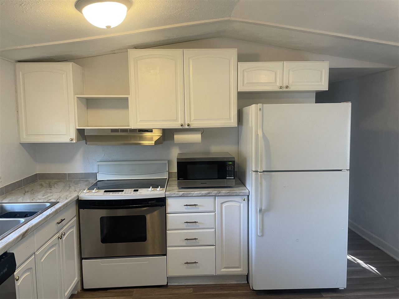 3268 E Road, Unit 43 Clifton, CO 81520 - Photo 6 of 15 a kitchen with appliances a refrigerator and cabinets