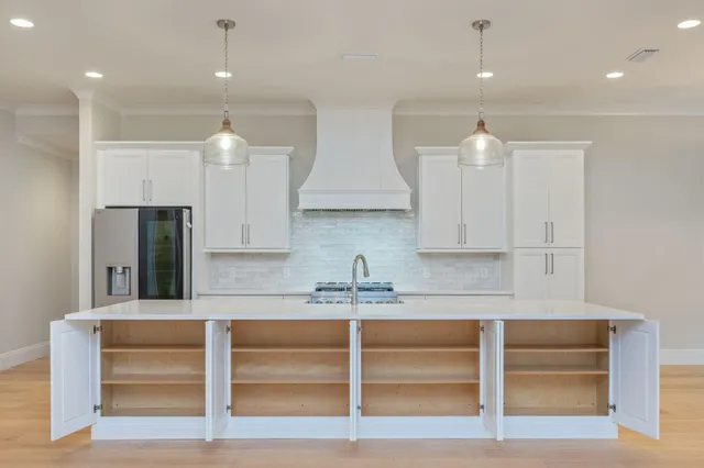 a stove top oven sitting inside of a kitchen