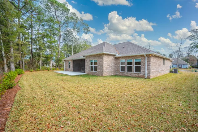 a view of a yard with plants and trees