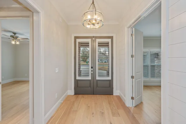 an empty room with fireplace and mirror