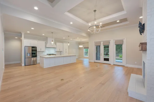 a large kitchen with kitchen island a sink stainless steel appliances and cabinets