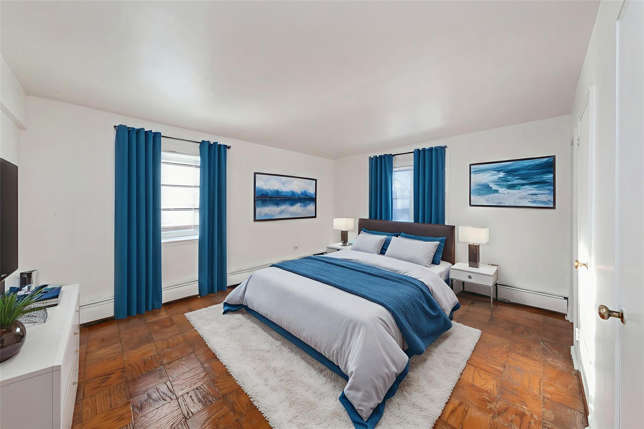 99-10 60th Avenue, Unit 1C1 Queens, NY 11368 - Photo 2 of 8 Bedroom featuring multiple windows, a baseboard heating unit, and baseboard heating