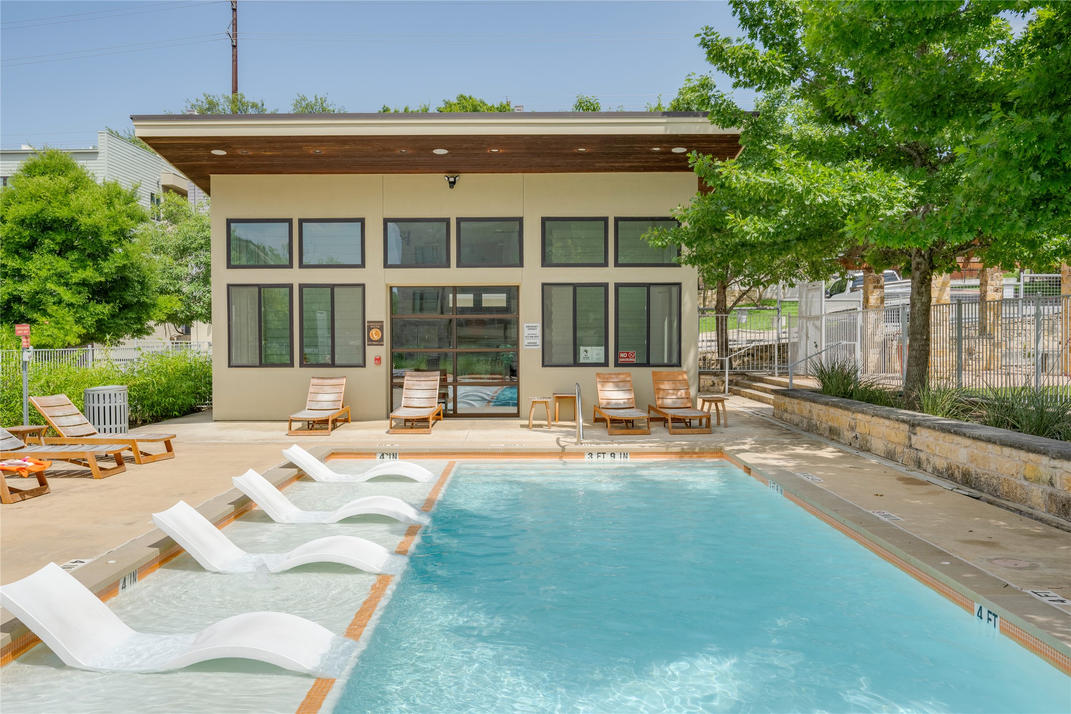 2724 Treble Lane, Unit 324 Austin, TX 78704 - Photo 26 of 29 Back of house featuring stucco siding, a storage structure, a community pool, an outdoor structure, and a patio area