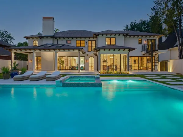 a front view of a house with swimming pool having outdoor seating