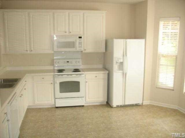 8309 Clasara Circle Raleigh, NC 27613 - Photo 2 of 9 a white stove top oven sitting inside of a kitchen