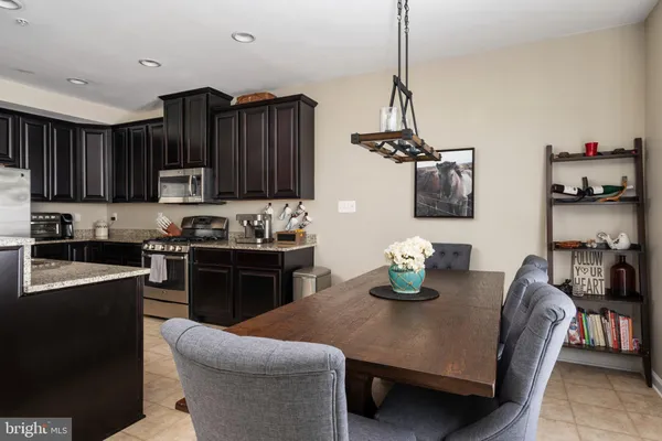 a kitchen with granite countertop a sink cabinets and stainless steel appliances
