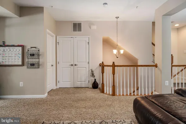 a view of a livingroom with furniture and staircase