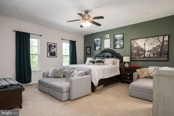 a bedroom with bed and a couch