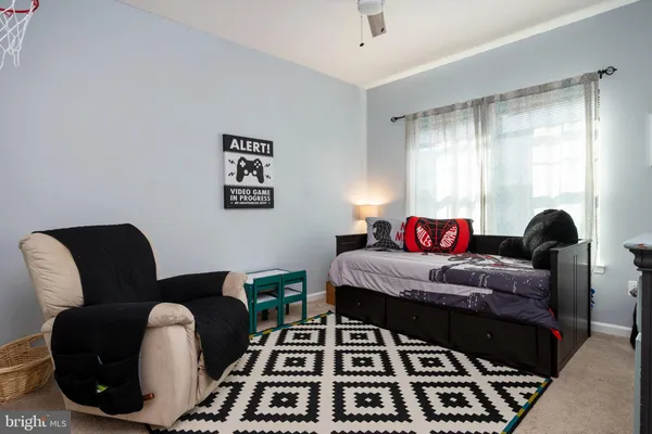 a bedroom with a bed and a chair