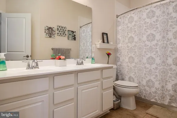 a bathroom with a sink toilet and mirror