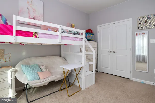 a utility room with cabinets and wooden floor