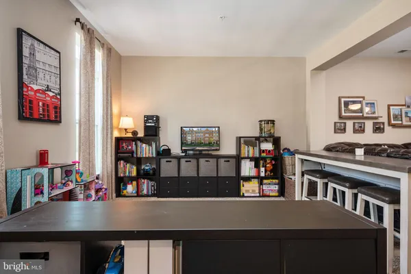 a view of a dining room with furniture and a book shelf