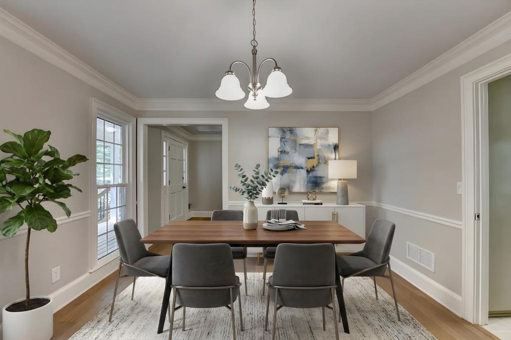 3791 Old Bridge Way Duluth, GA 30096 - Photo 19 of 58 a dining room with wooden floor a chandelier a wooden table and chairs