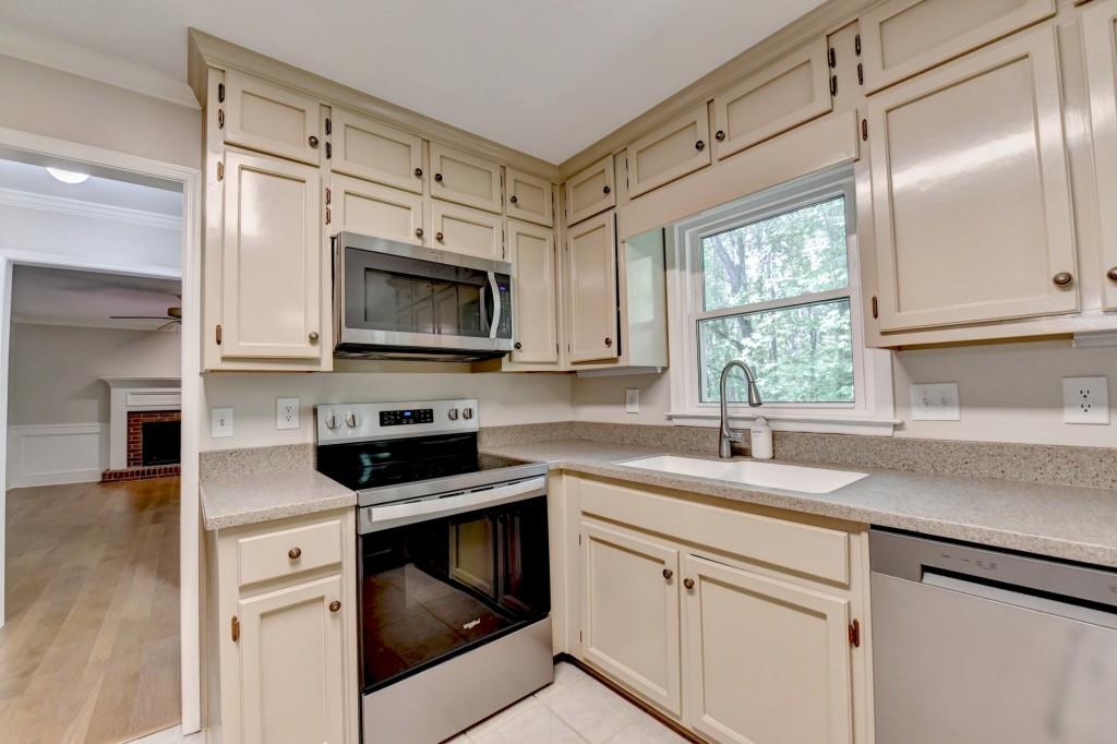 3791 Old Bridge Way Duluth, GA 30096 - Photo 22 of 58 a kitchen with granite countertop white cabinets stainless steel appliances and a sink