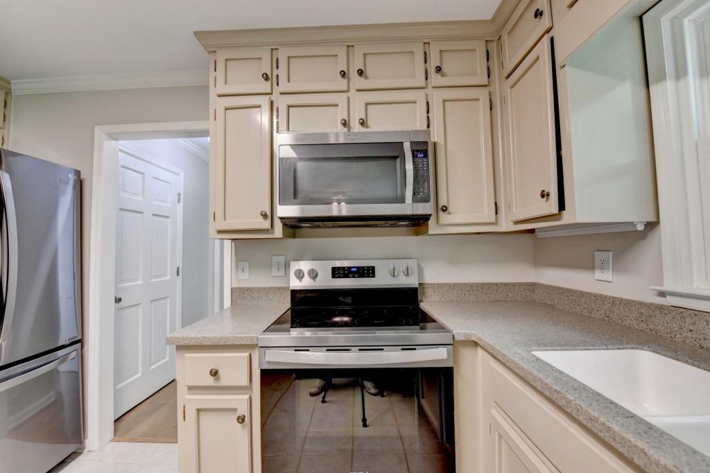 3791 Old Bridge Way Duluth, GA 30096 - Photo 23 of 58 a kitchen with stainless steel appliances granite countertop a sink stove and refrigerator