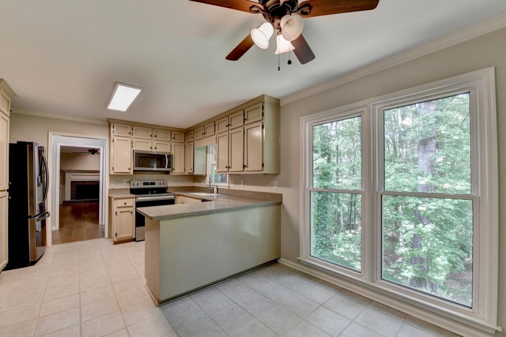 3791 Old Bridge Way Duluth, GA 30096 - Photo 25 of 58 a kitchen with stainless steel appliances a stove sink microwave and refrigerator