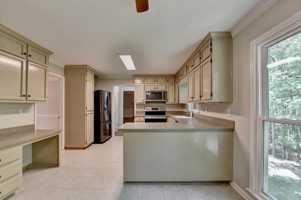 3791 Old Bridge Way Duluth, GA 30096 - Photo 26 of 58 a large kitchen with stainless steel appliances granite countertop a large counter top and a refrigerator