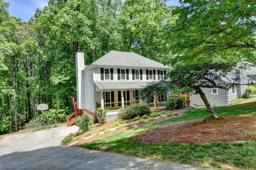 3791 Old Bridge Way Duluth, GA 30096 - Photo 3 of 58 a front view of a house with a garden