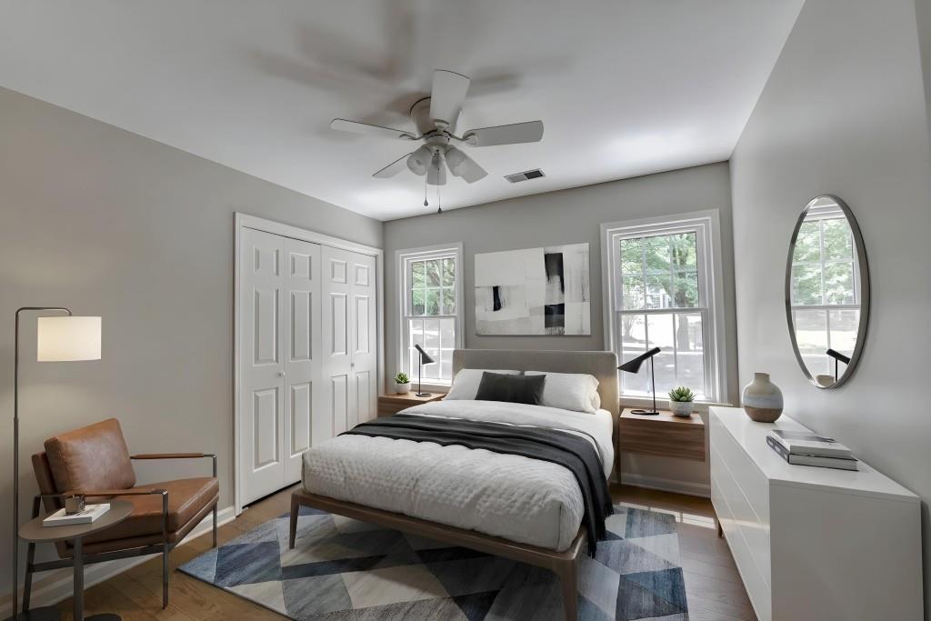 3791 Old Bridge Way Duluth, GA 30096 - Photo 39 of 58 a bedroom with a bed a mirror on dresser and a chandelier